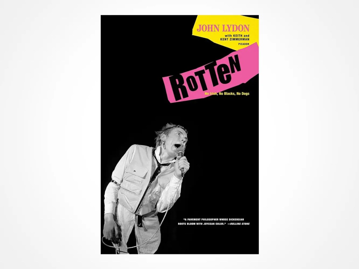 Book cover for Rotten: No Irish, No Blacks, No Dogs by John Lydon, featuring a black-and-white photo of a man singing into a microphone, with bold yellow and pink title graphics and text.