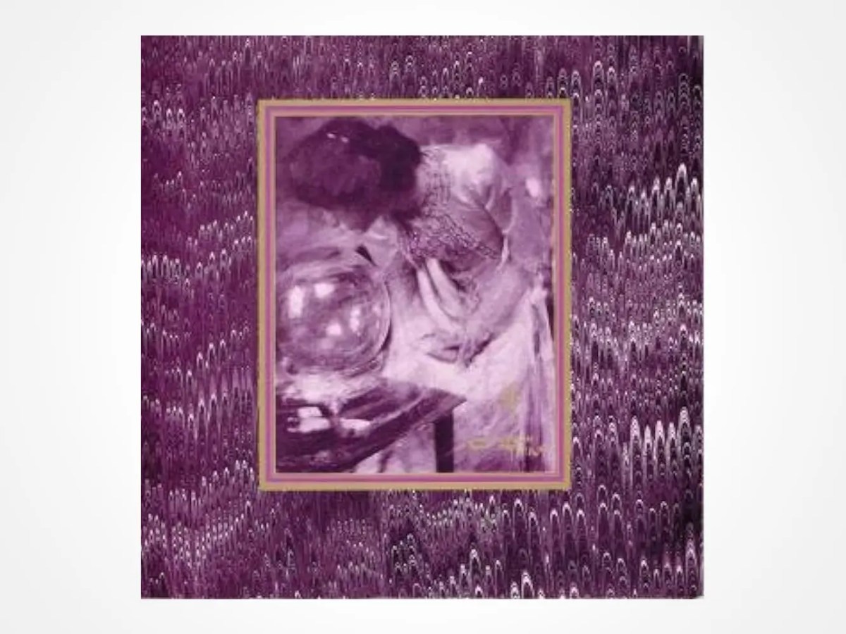 A purple-tinted image of a woman leaning over and peering into a large crystal ball on a table, framed in gold, set against a textured purple patterned background.